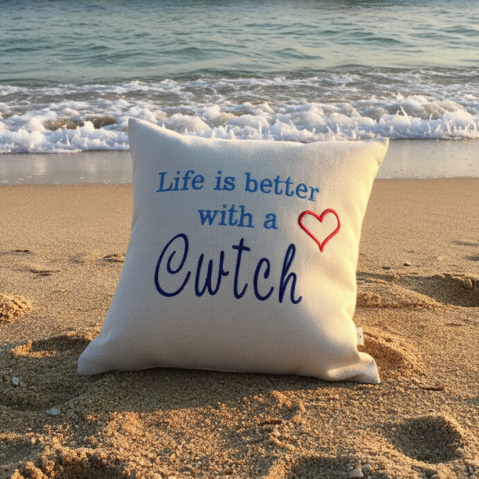 Cwtch Cushion on golden sand