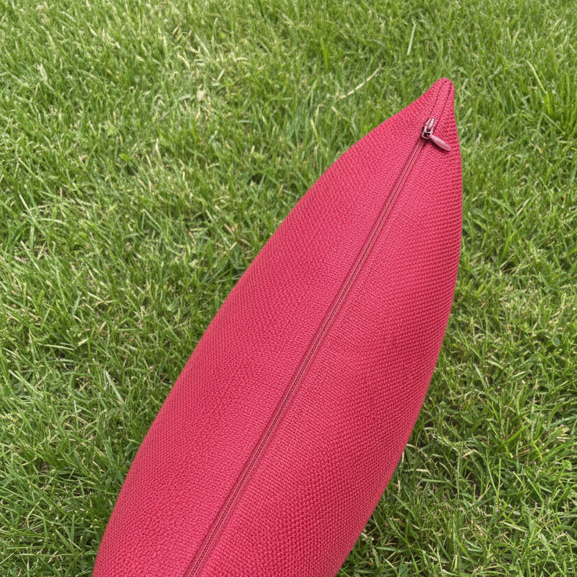 Red Cushion Zip Detail on Grass